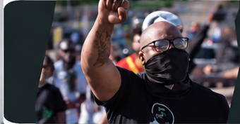 Community member raising a fist during ComForce outreach